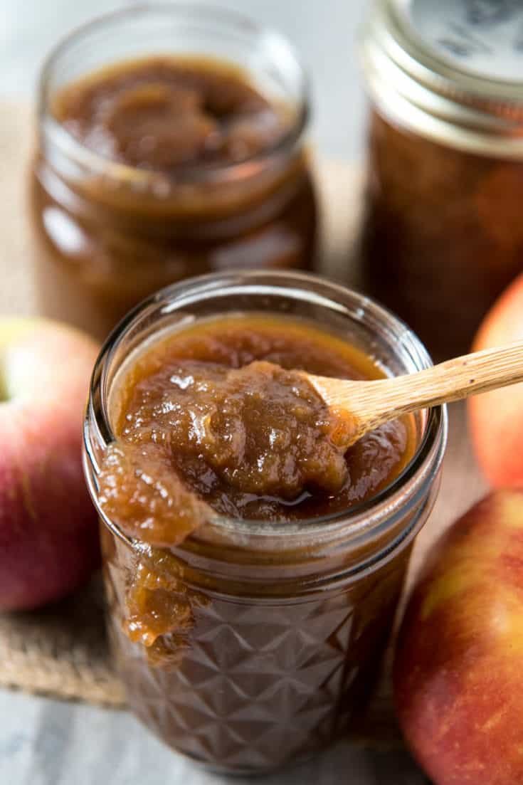 Slow cooker apple butter bubbling in jar, caramel apple scent, cinnamon, nutmeg, cozy kitchen