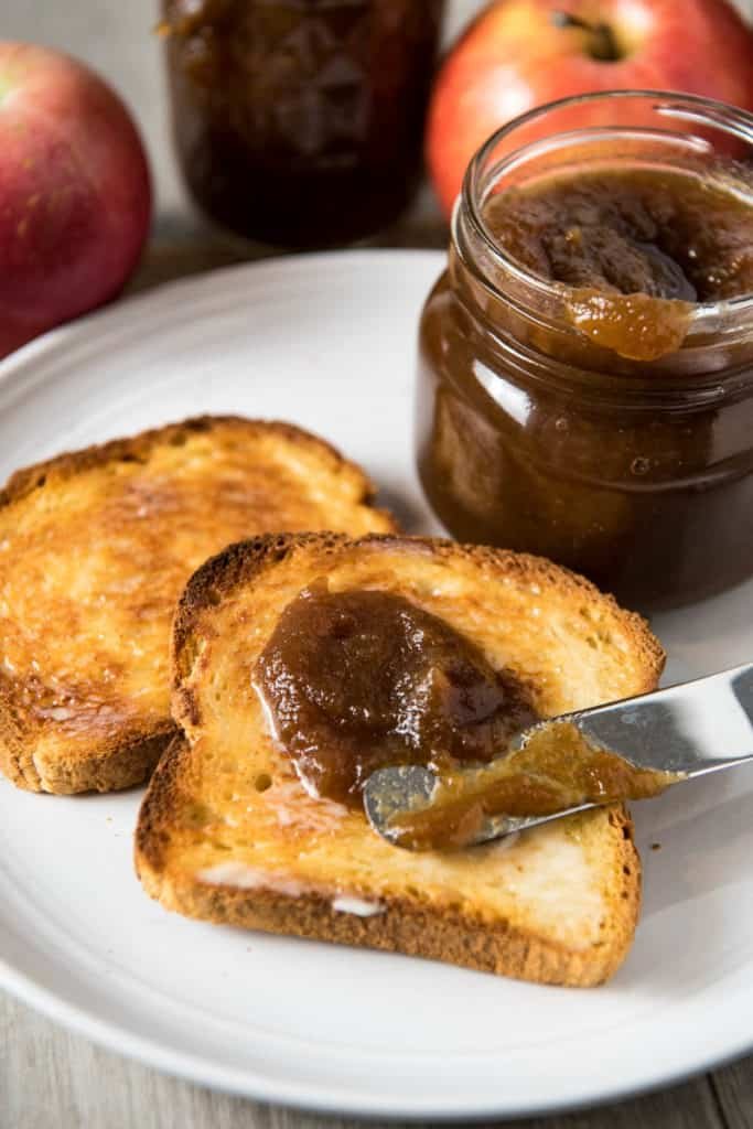 Golden apple butter in a mason jar, smooth texture, fragrant cinnamon and cloves, autumn vibes