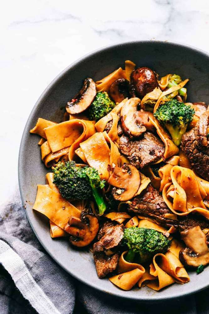 Beef broccoli mushroom wide noodle stir fry with tender beef, crisp broccoli, and glossy noodles