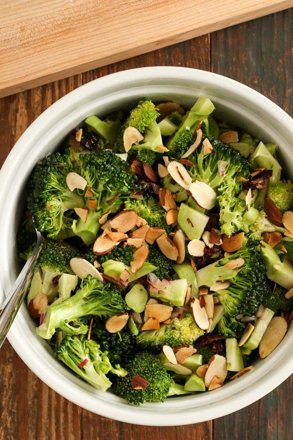 Holiday broccoli salad featuring cranberries, toasted almonds, orange zest, raisins, and a citrus‑honey dressing