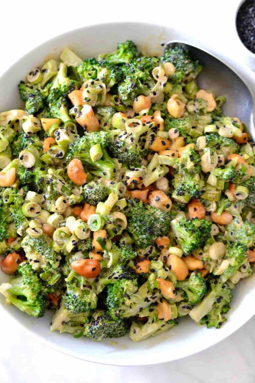 Classic broccoli salad with sun-dried tomatoes, cheddar, bacon, raisins, and a creamy mayo‑herb dressing