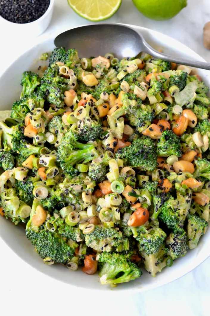 Classic broccoli salad with crisp florets, bacon, cheddar, red onion, raisins, and creamy mayo dressing
