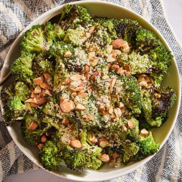Grilled broccoli salad with crisp florets, lemon vinaigrette, toasted almonds, raisins, and shaved parmesan cheese
