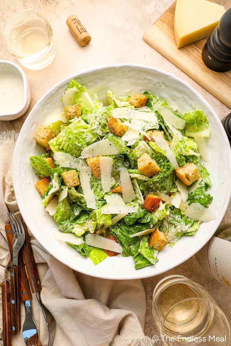 Authentic classic caesar salad prepared with crisp romaine, crunchy croutons, shaved parmesan, creamy dressing.