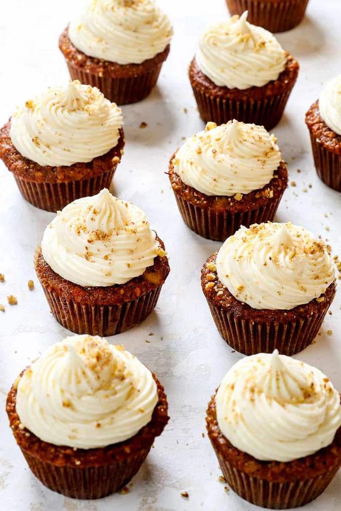 Moist carrot cupcake with vanilla‑infused cream cheese frosting and toasted walnuts