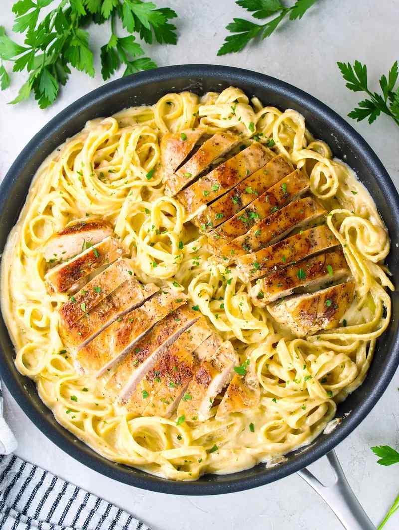 Classic fettuccine chicken alfredo with tender chicken and silky parmesan cream sauce on pasta.
