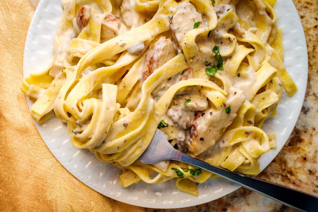 Classic fettuccine chicken alfredo with tender chicken and silky parmesan cream sauce over pasta.