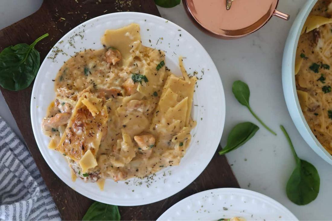 Gluten-free chicken alfredo featuring tender chicken and silky parmesan cream sauce over fettuccine.