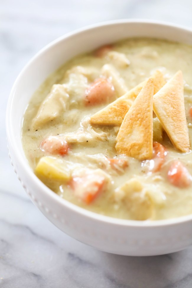 Classic creamy chicken pot pie soup with tender chicken, carrots, peas, potatoes, and a flaky pastry crust topping