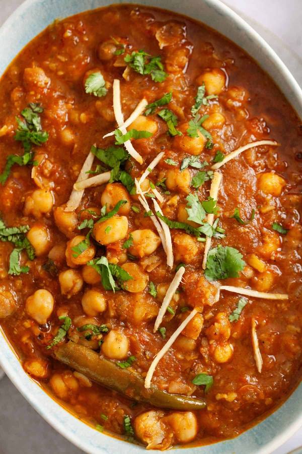 Creamy chickpea curry in golden coconut sauce with fragrant spices, cilantro, and steamed basmati rice.