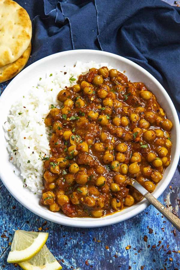 Quick classic chana masala with tender chickpeas, rich tomato curry sauce, spices, cilantro, and naan.
