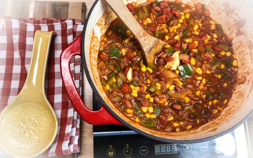 Roasted butternut squash vegetarian chili in a bowl with pumpkin seeds and sour cream