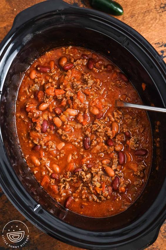 Aromatic slow‑cooked beef chili with beans, melted cheese, sour cream, jalapenos, coffee infusion