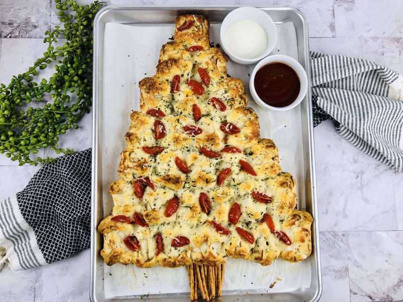 Pull‑apart pizza bread shaped like a Christmas tree, topped with mozzarella and pepperoni ornaments