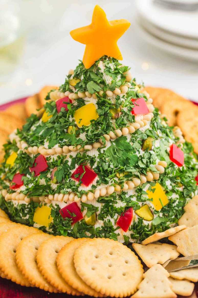 Green herb‑infused cheese ball shaped like a tree, surrounded by assorted crackers