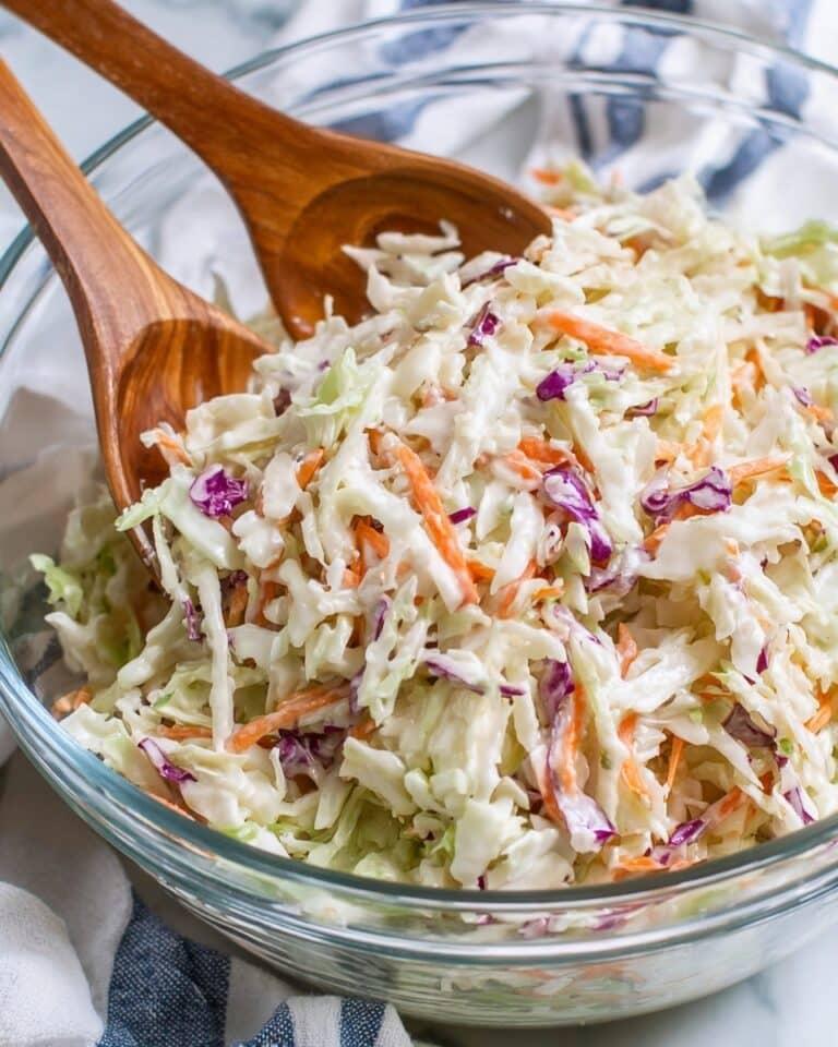 Herbaceous classic creamy coleslaw with crisp cabbage ribbons and creamy dressing offering cool crunch.