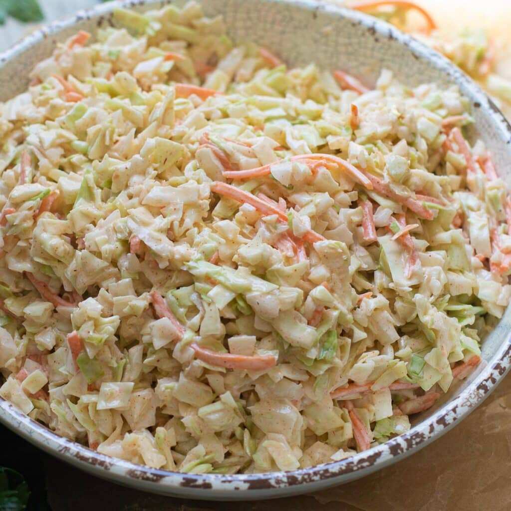 Peppery southern coleslaw with crisp green cabbage and sharp cider dressing for cookouts