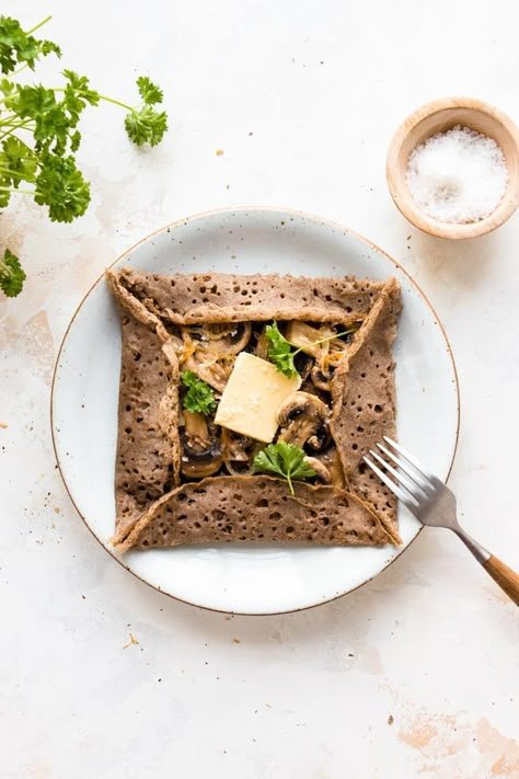 Thin golden French crepes filled with fresh berries, topped with powdered sugar and fresh mint