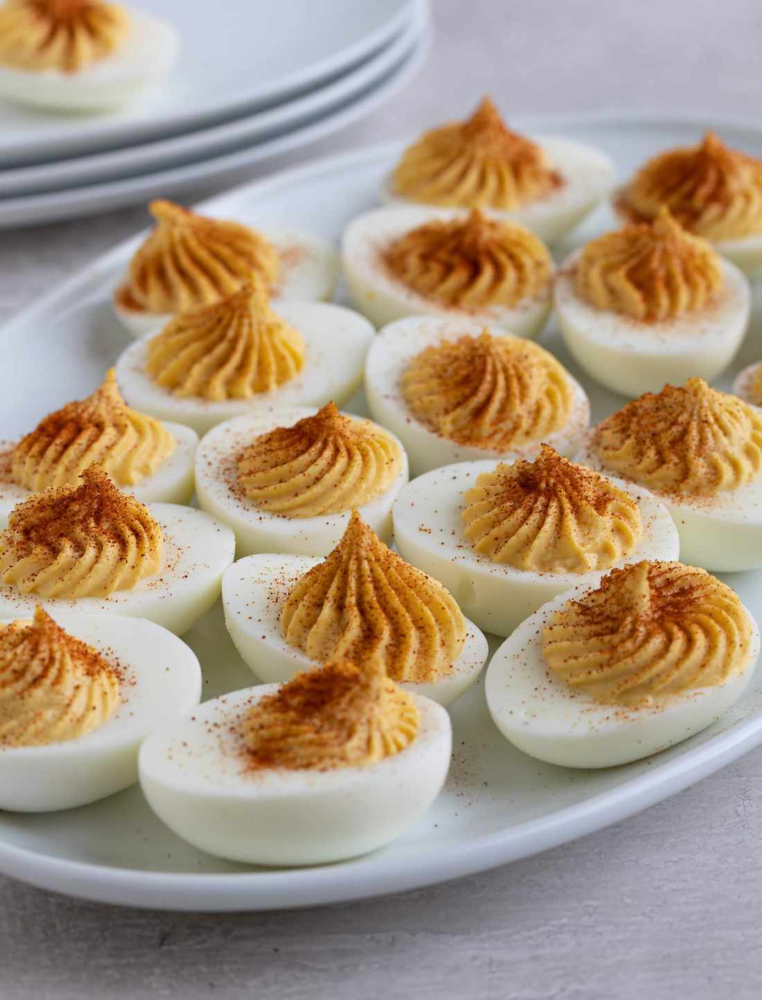 Creamy yolk filling with paprika, chives, and bacon bits on hard-boiled eggs