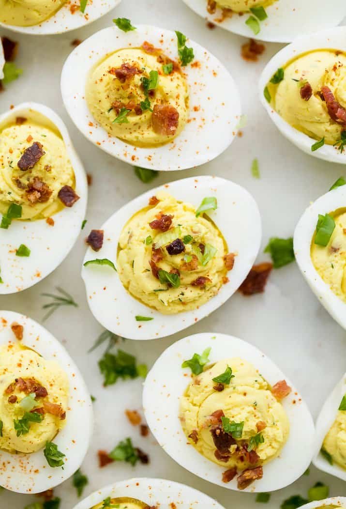 Bacon deviled eggs with creamy yolk filling, smoky bacon, paprika, and fresh chives
