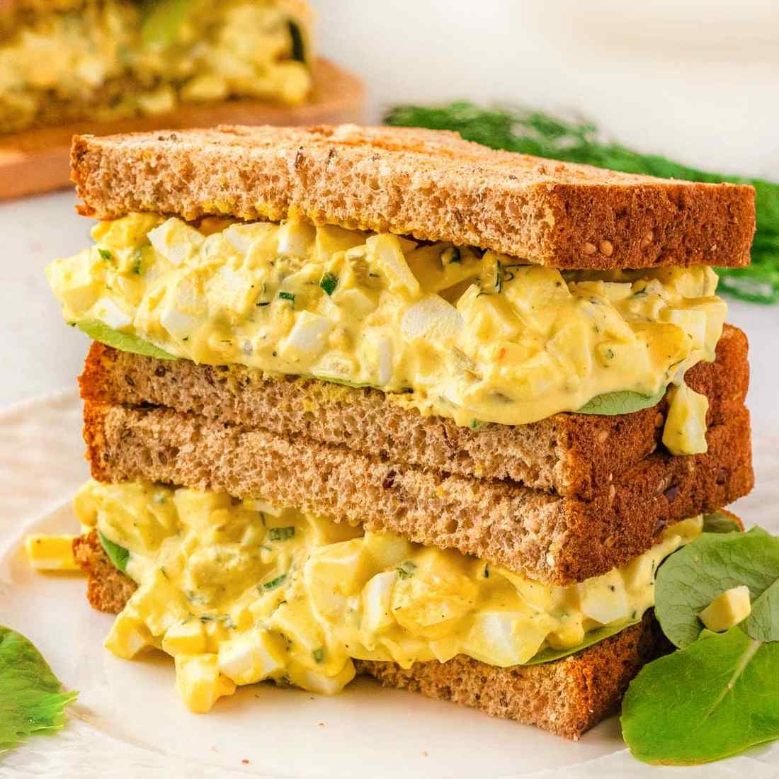 Classic creamy egg salad featuring chopped hard-boiled eggs, rich mayo, fresh parsley, and crunchy celery in a party platter
