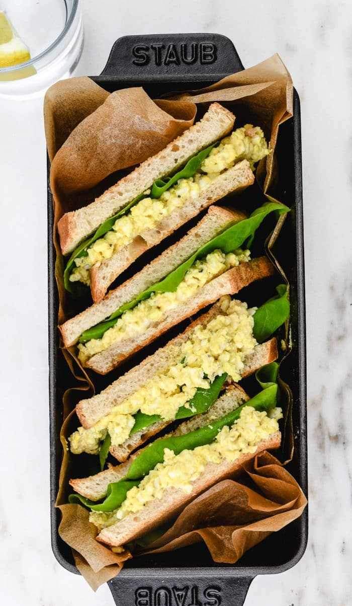 Creamy herb egg salad sandwich with chopped hard-boiled eggs, tangy Dijon, fresh parsley, on toasted whole‑grain bread