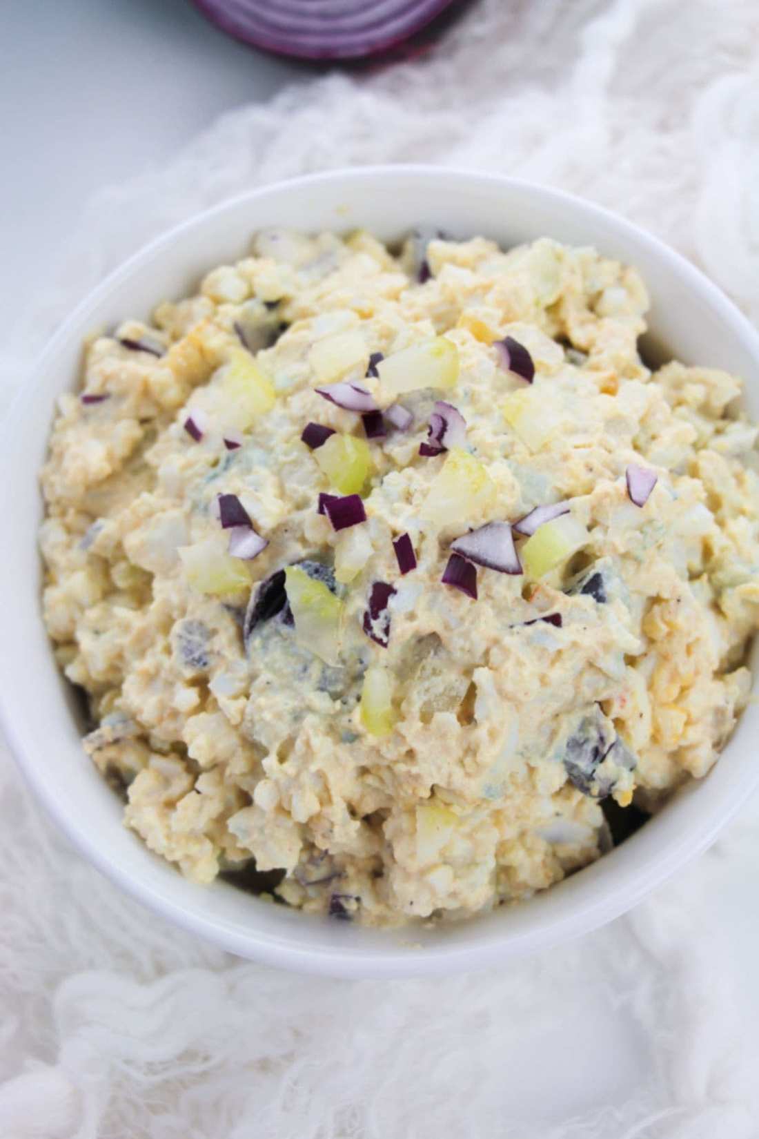 Classic creamy egg salad with chopped hard‑boiled eggs, silky mayo, fresh herbs, and a bright green garnish