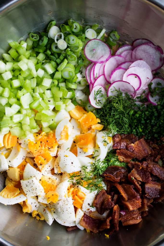 Bacon‑crunch egg salad with chopped hard‑boiled eggs, creamy mayo, fresh herbs, and crispy bacon bits on a bed of lettuce
