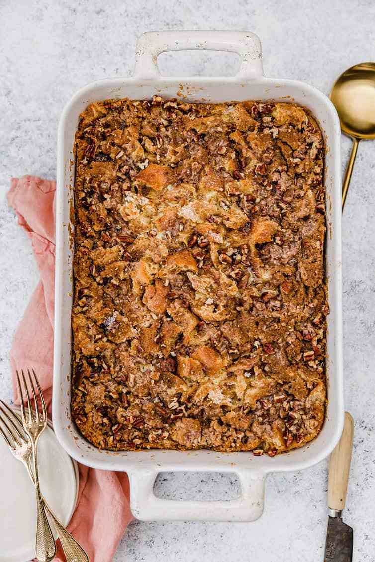 Rustic French toast casserole with golden custardy cubes, sliced bananas, and maple syrup glaze