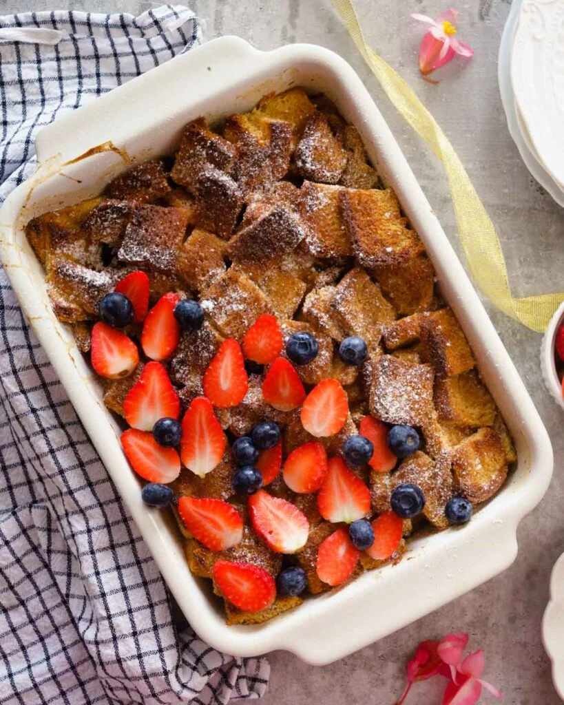 Brioche French toast casserole, buttery golden cubes, caramelized crust, sweet vanilla glaze