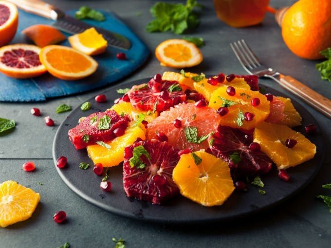 Tropical fresh fruit salad with mango, pineapple, papaya, and a lime‑mint drizzle