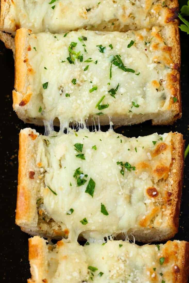 Cheesy garlic bread with golden crust, melted mozzarella, fragrant garlic, and parsley