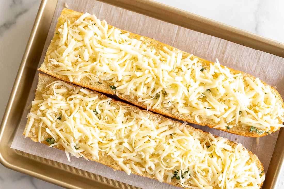 Golden cheesy garlic bread with bubbling mozzarella, buttery crust, and fragrant herbs