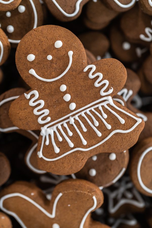 Elegant gingerbread ballerina cookies dressed in detailed royal icing gowns and ribbons