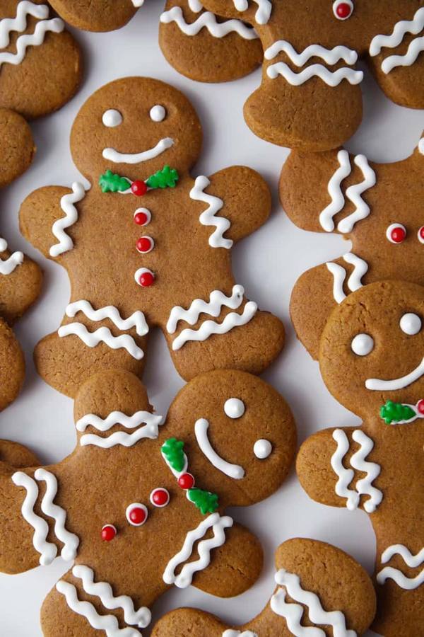 Gingerbread men adorned with vibrant red and green royal icing, festive holiday charm