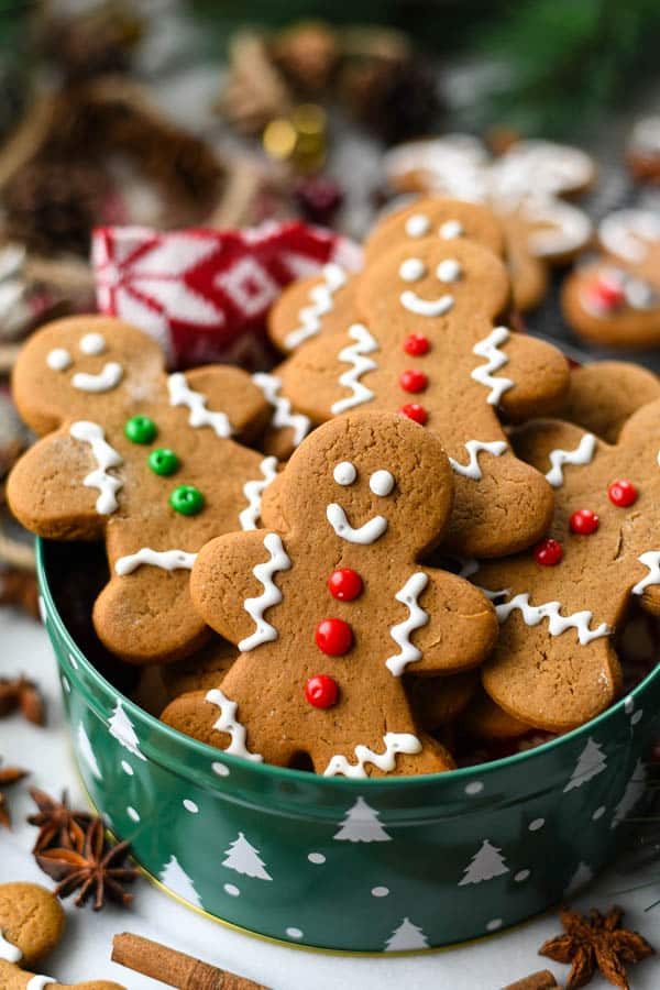 Petite gingerbread men packed in a festive Christmas gift tin, ready to share