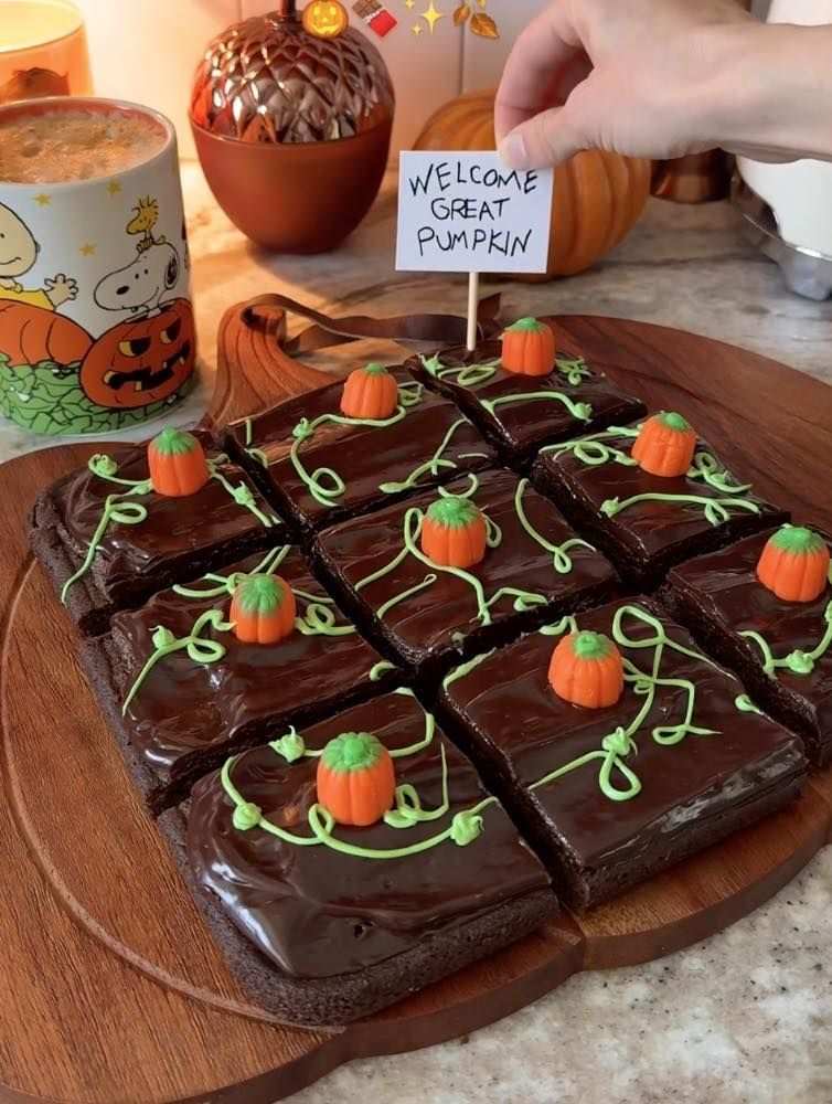 Fudgy chocolate brownies with pumpkin spice swirls and white chocolate chips on a cooling rack
