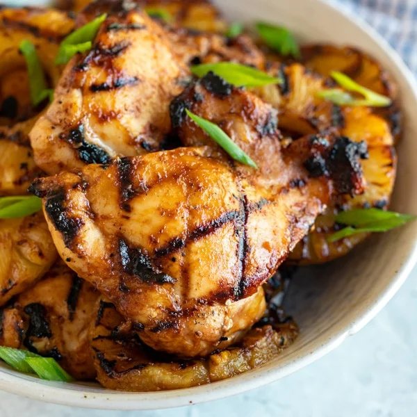 Grilled pineapple chicken with crisp broccoli, tangy dressing, toasted nuts, dried fruit, and cheese.