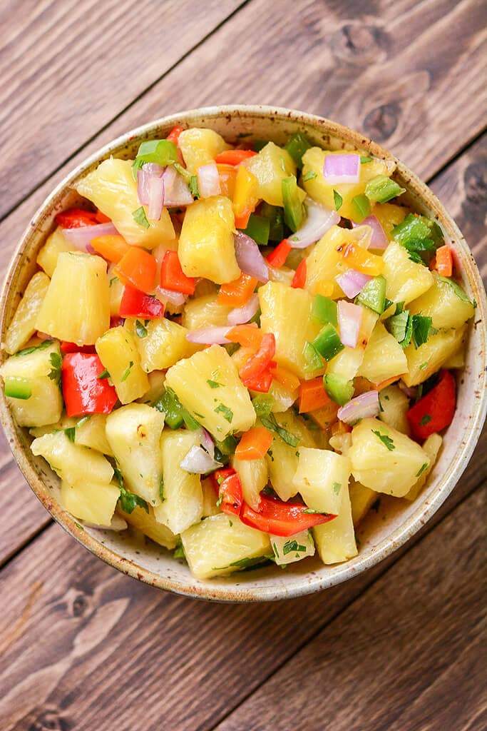 Grilled pineapple salsa with crisp broccoli, tangy dressing, toasted nuts, dried fruit, and cheese.