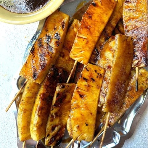 grilled pineapple with crisp broccoli florets, nuts, dried fruit, cheese, and savory dressing