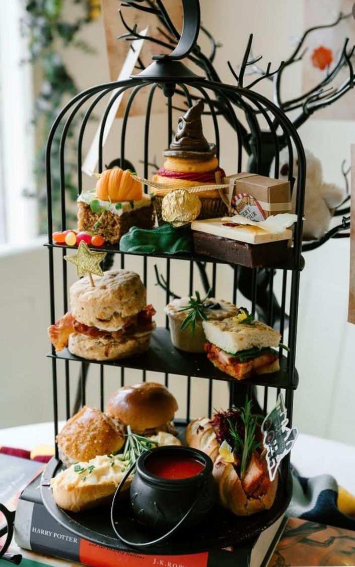 Lemon drizzle mini scones with white glaze arranged in a vintage birdcage