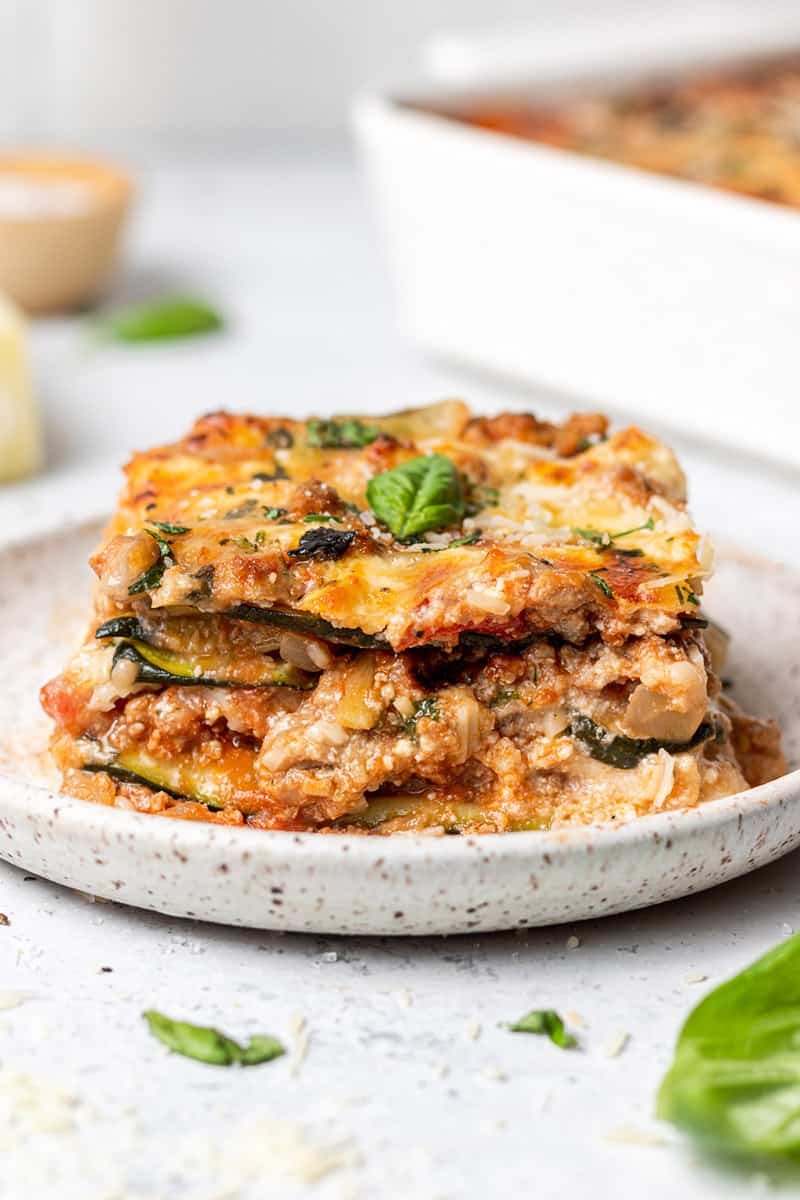 Thin zucchini ribbons replace pasta in a layered lasagna, topped with golden cheese.