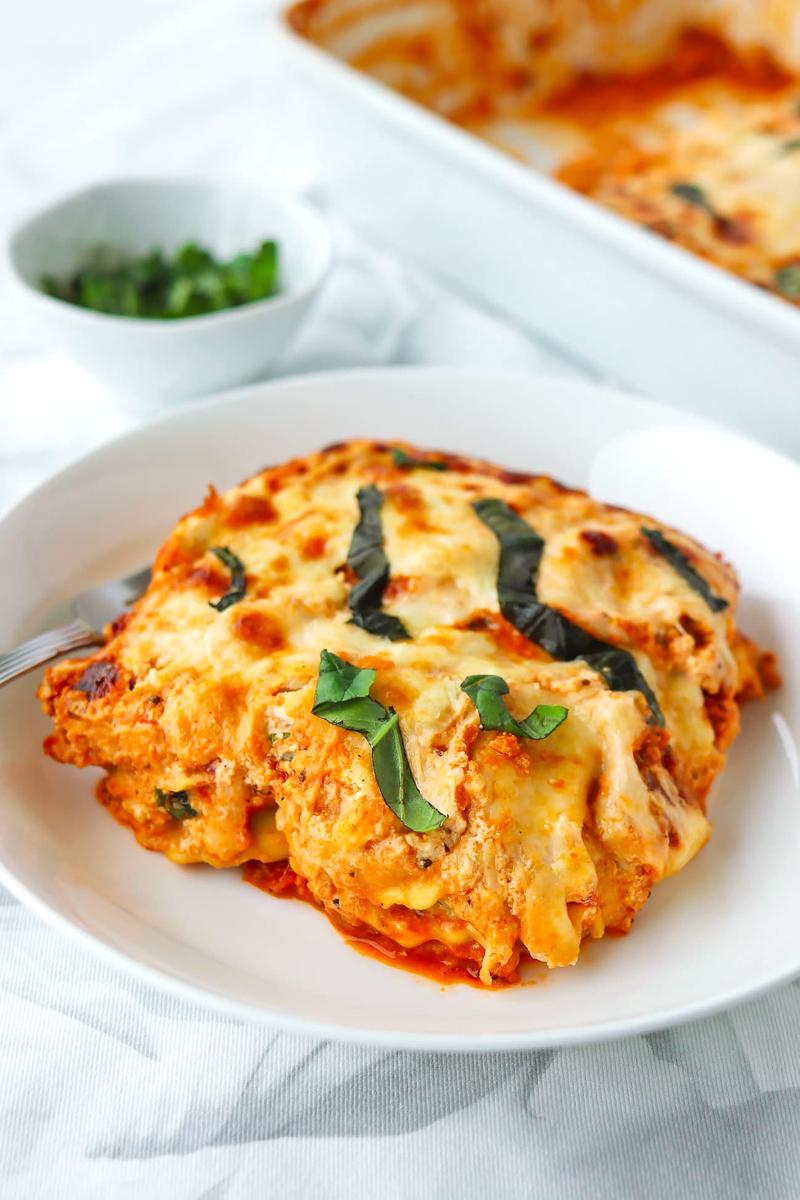 Spicy buffalo chicken lasagna layered with creamy cheese and topped with blue cheese crumble