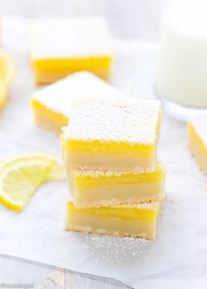 Classic lemon bars with golden shortbread crust, bright lemon curd, dusted with powdered sugar