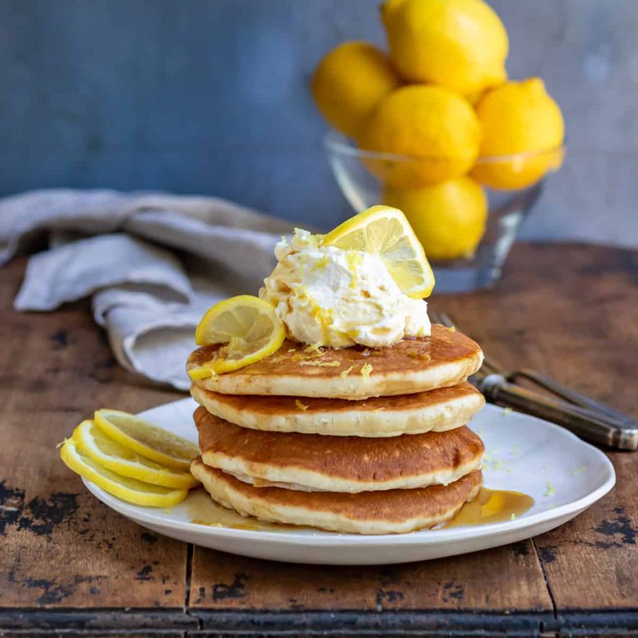 Light lemon pancakes drizzled with lemon curd and fresh berries