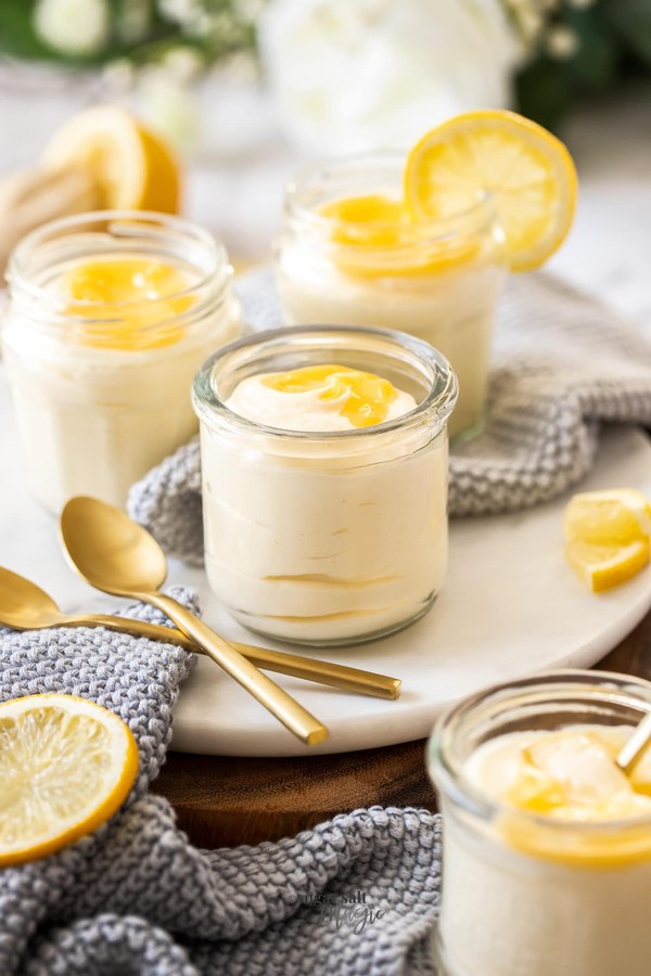 Velvet‑smooth lemon mousse dotted with bright lemon curd and edible flowers