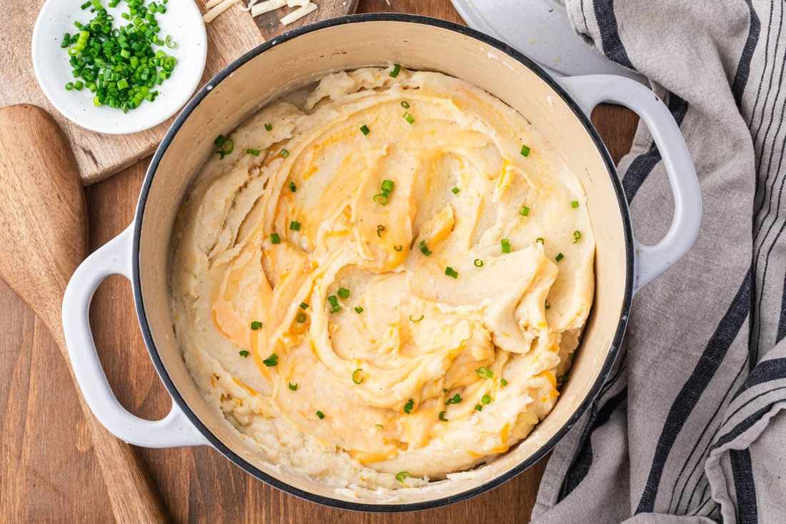 Creamy mashed potatoes blended with sharp white cheddar and Parmesan cheese, sprinkled with paprika