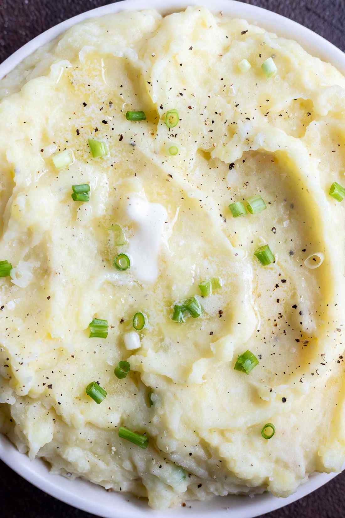 Buttermilk mashed potatoes with minced chives, fresh dill, melted butter, in warm serving bowl