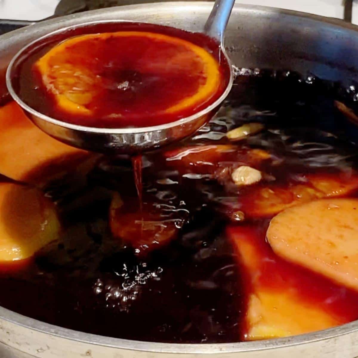 Rich spiced mulled wine topped with freshly grated nutmeg, orange peel, and cinnamon sticks