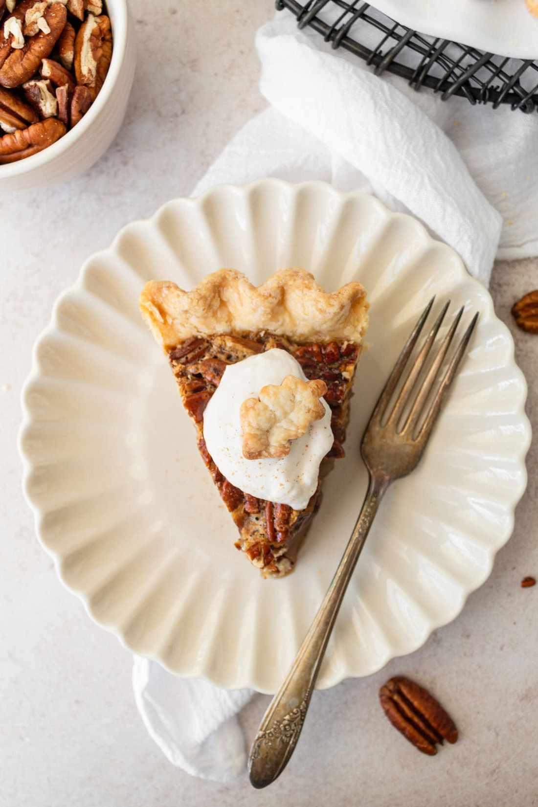 Slice of golden classic pecan pie with rich dark molasses filling